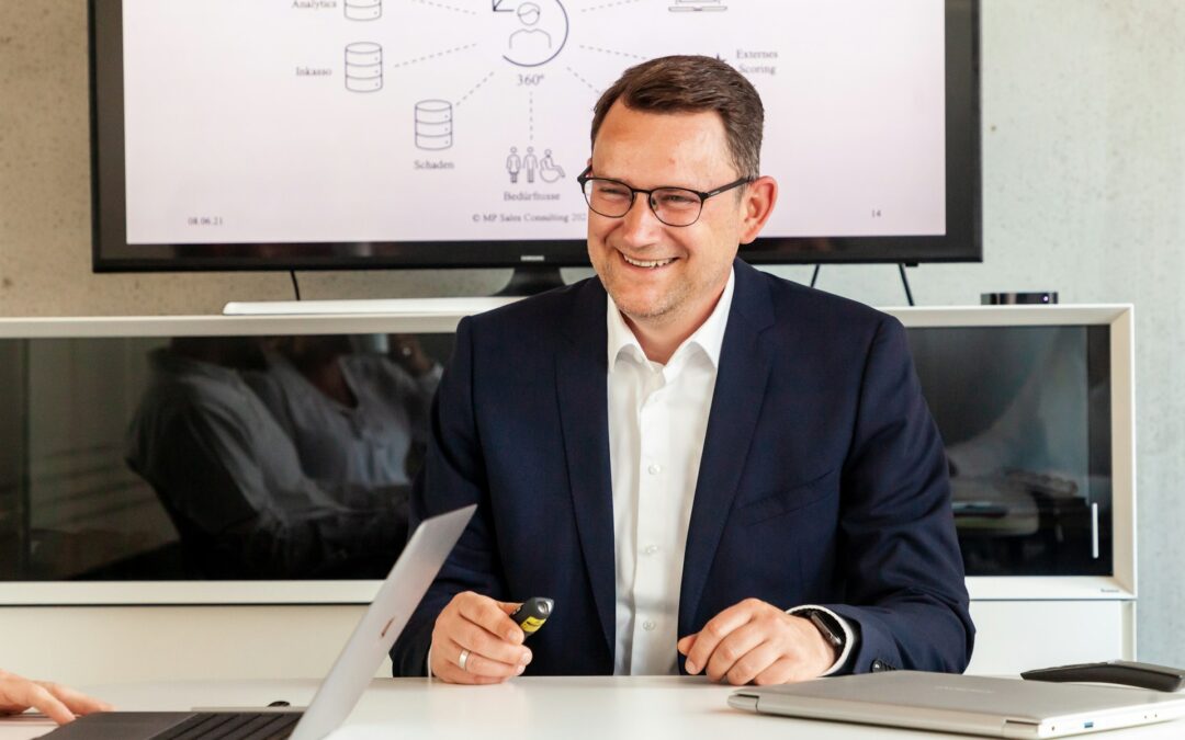 Smiling company director in a suit at his desk